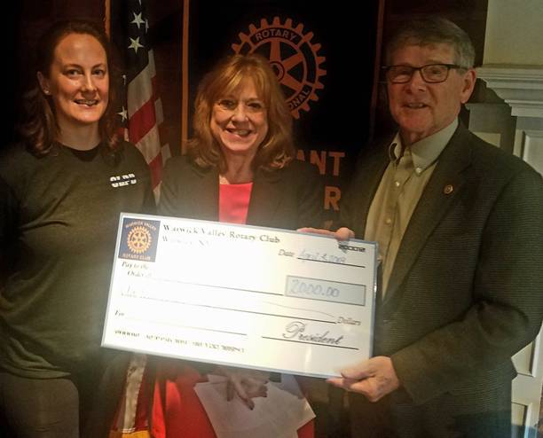 Katherine Brieger (center), Executive Director of the Warwick Area Migrant Committee (WAMC) is shown accepting the donation from Rotary President Dave Eaton (right). At left is Past President Katie Hansen. Photo courtesy of Jim LaPlante
